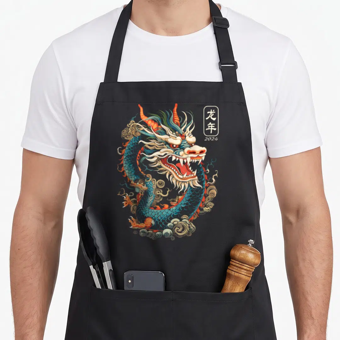 Retro chinese dragon apron - Coiled blue dragon with red accents and vertical box containing Year of the Dragon 2024 — shown on a black cotton canvas apron against a white background