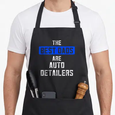 Detailer auto detailing apron - Stacked white text The Best Dads Are Auto Detailers inside blue rectangle — shown on a black cotton canvas apron against a white background