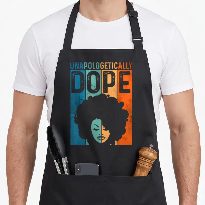Unapologetically pride apron - Retro graphic of woman's afro silhouette over blue teal orange grey stripes — shown on a black cotton canvas apron against a white background