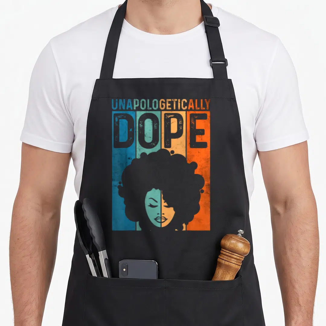 Unapologetically pride apron - Retro graphic of woman's afro silhouette over blue teal orange grey stripes — shown on a black cotton canvas apron against a white background