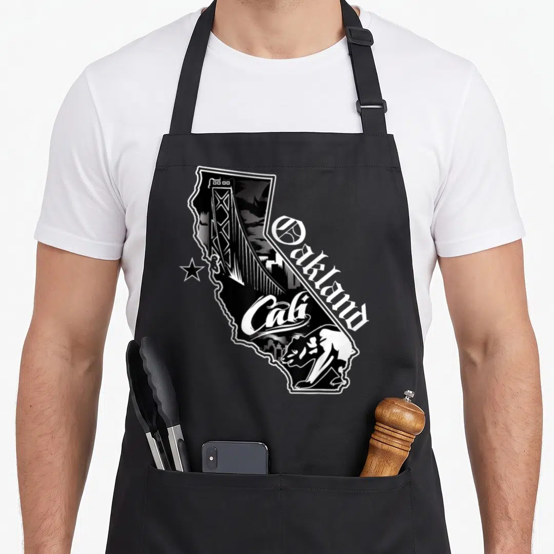 California oakland apron - California state outline with bridge skyline bear and Oakland Cali text in black white line — shown on a black cotton canvas apron against a white background