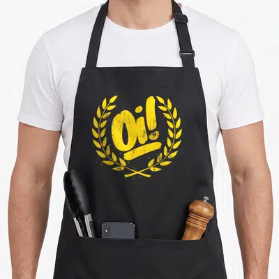 Ska punk rock apron - Distressed yellow Oi! text inside a circular laurel wreath — shown on a black cotton canvas apron against a white background