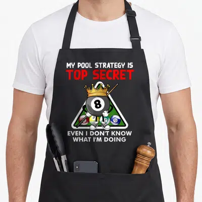Pool player billiards apron - Cartoon 8-ball with crown and cue inside triangle rack with strategic text — shown on a black cotton canvas apron against a white background
