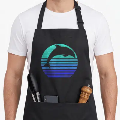 Dolphin animal retro apron - Grey dolphin silhouette in a teal and blue gradient circle with horizontal stripes — shown on a black cotton canvas apron against a white background