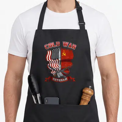 Cold wars classic apron - Red white blue missile crossed rifles COLD WAR VETERAN ribbon design — shown on a black cotton canvas apron against a white background