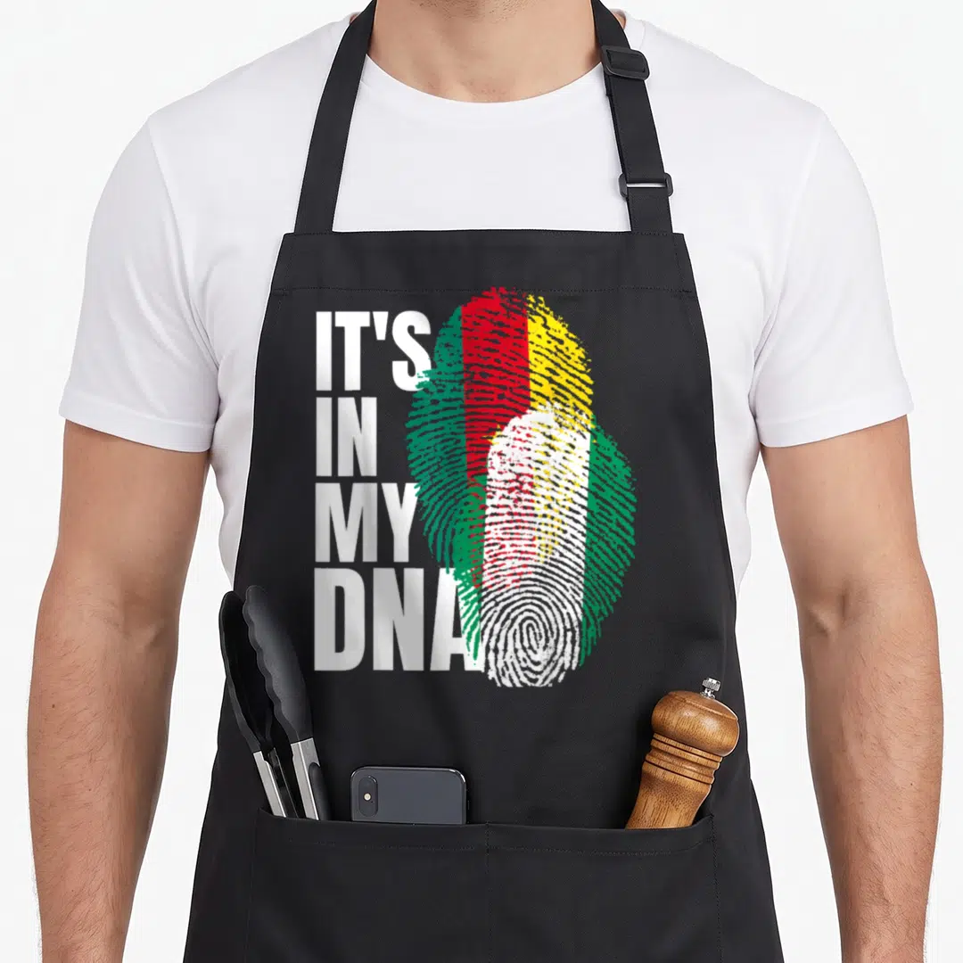 Cameroon heritage aprons - Stacked IT'S IN MY DNA text next to a fingerprint filled with red yellow green and white — shown on a black cotton canvas apron against a white background