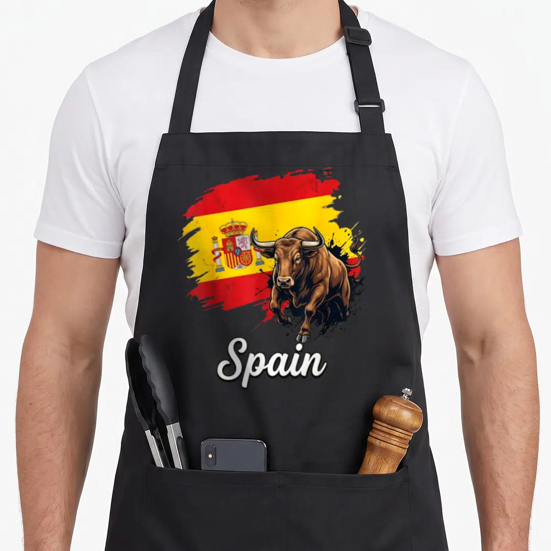 National spanish aprons - Realistic brown bull on red yellow brush stroke flag with white Spain script text — shown on a black cotton canvas apron against a white background