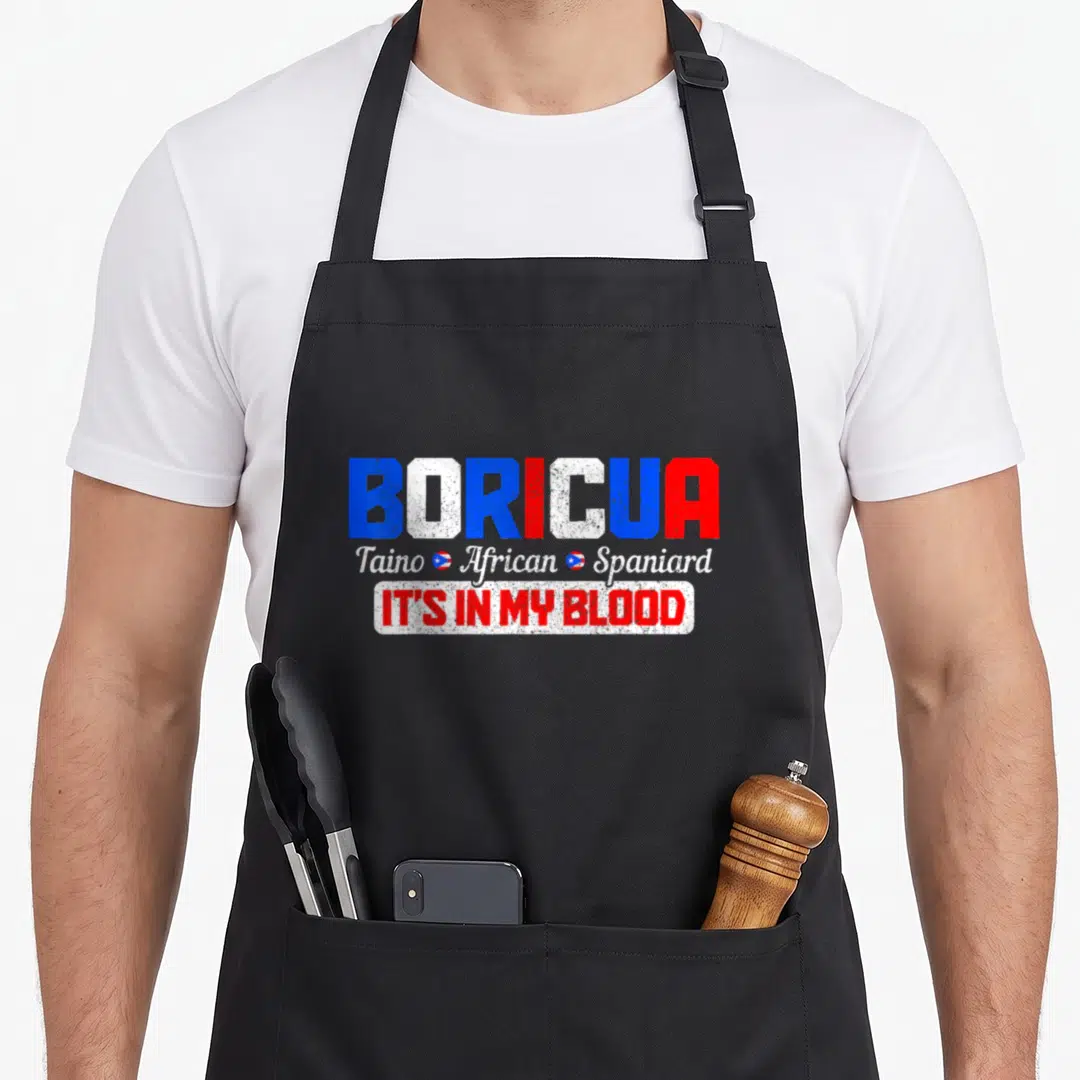 Boricua spanish aprons - Distressed BORICUA text in blue white red with Taino African Spaniard script and two small — shown on a black cotton canvas apron against a white background