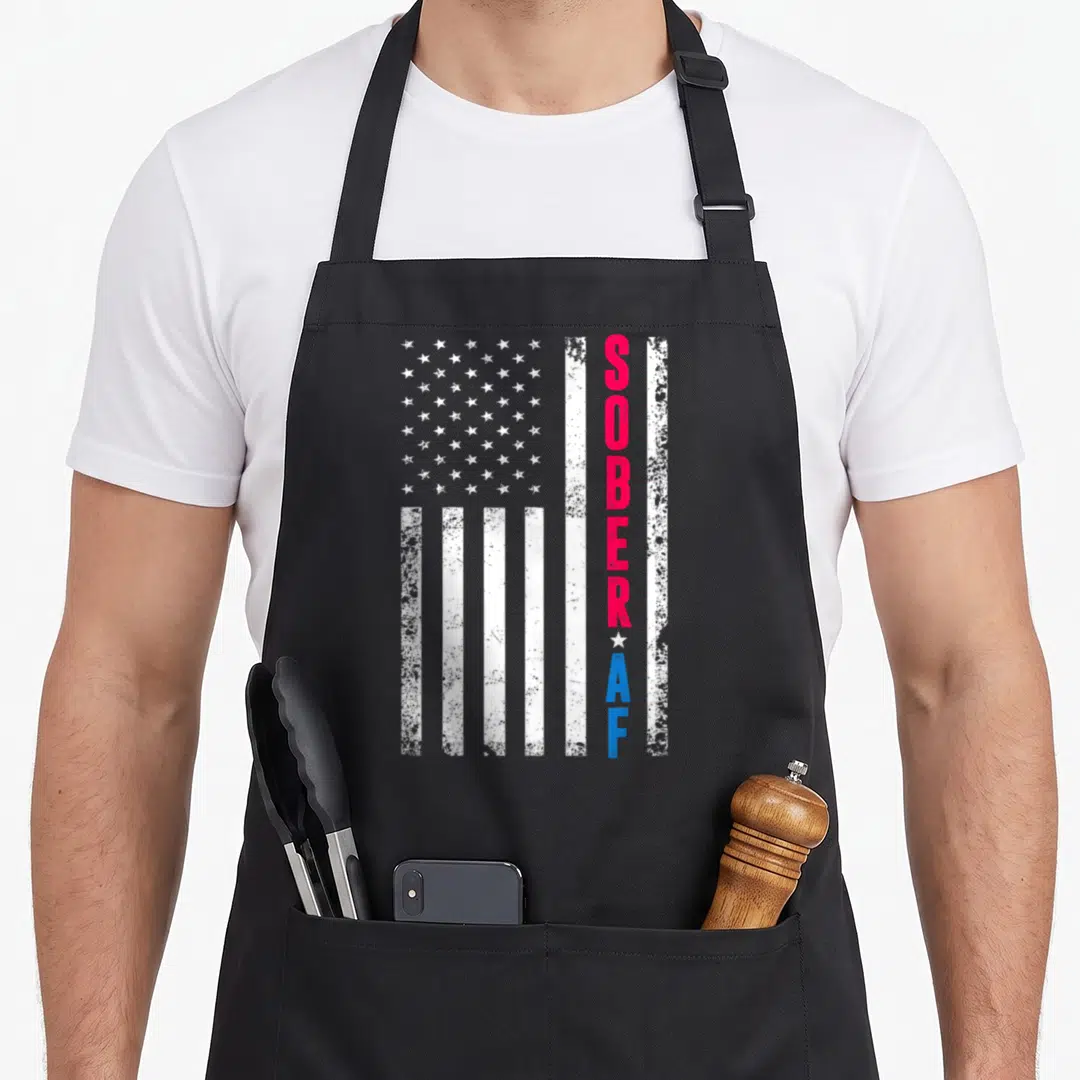 Sober us aprons - Distressed USA flag with vertical red SOBER and blue AF text separated by a white star — shown on a black cotton canvas apron against a white background