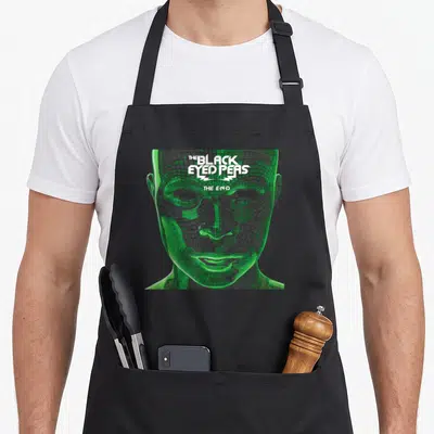 Peas eyed apron - Green digital face with white The Black Eyed Peas The End text overlay — shown on a black cotton canvas apron against a white background