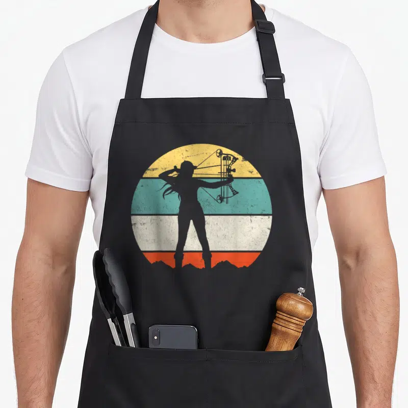 Teez bow apron - Grey archer silhouette with compound bow inside yellow teal white orange striped circle — shown on a black cotton canvas apron against a white background