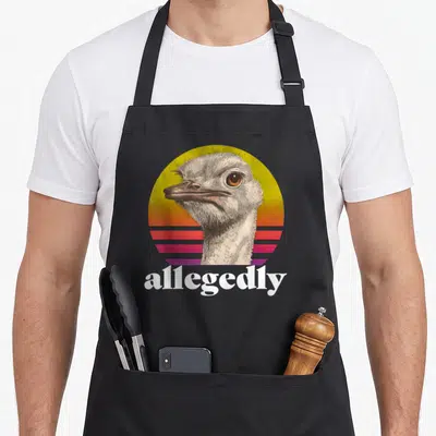 Allegedly ostrich dad apron - Retro ostrich head on yellow orange pink purple striped circle with allegedly text — shown on a black cotton canvas apron against a white background