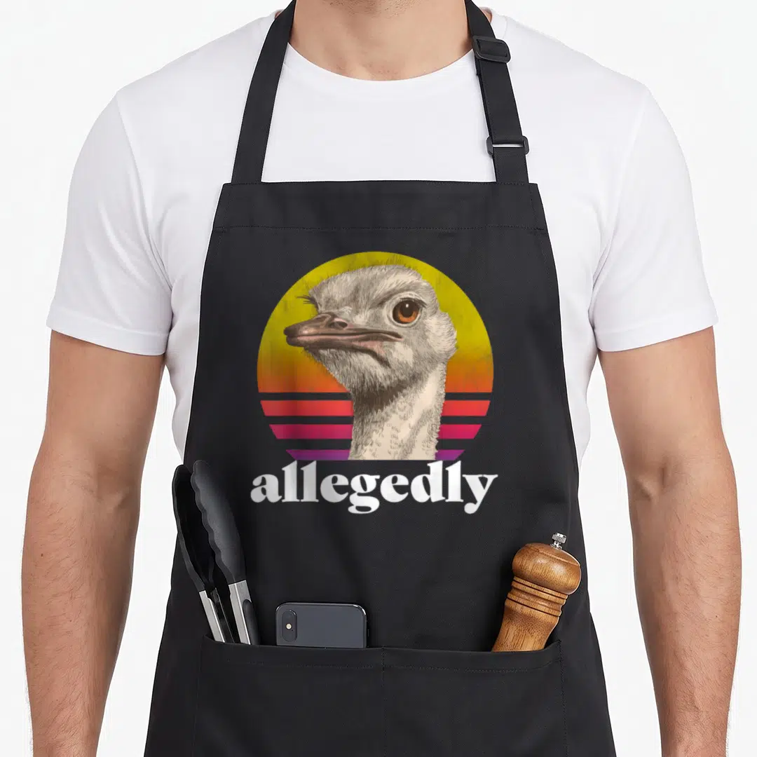 Allegedly ostrich dad apron - Retro ostrich head on yellow orange pink purple striped circle with allegedly text — shown on a black cotton canvas apron against a white background