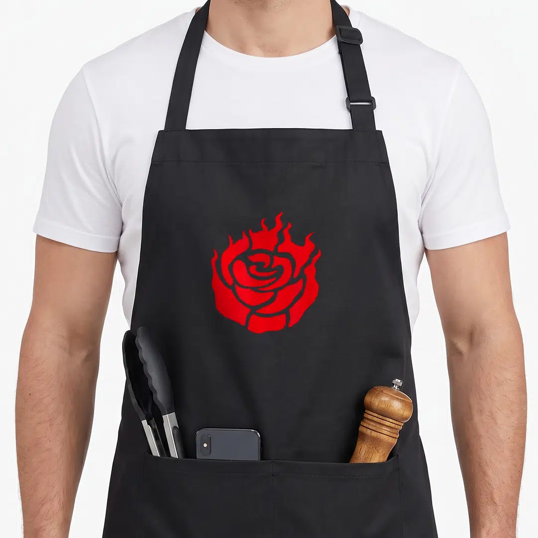 Flame floral apron - Red rose with flames emerging from petals in minimalist style — shown on a black cotton canvas apron against a white background