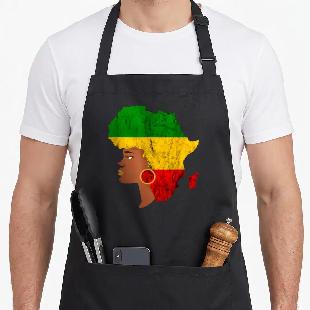 Rasta pride apron - Woman profile merged with Africa map in green yellow red brown horizontal bands — shown on a black cotton canvas apron against a white background