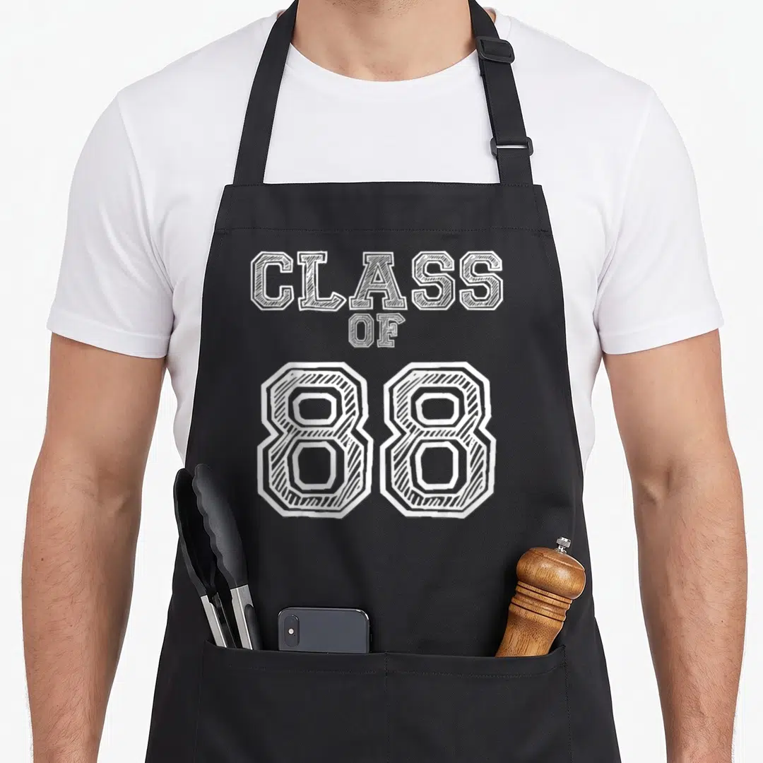 Reunion alumni apron - White stacked text reading CLASS OF 88 in hatched athletic font style — shown on a black cotton canvas apron against a white background