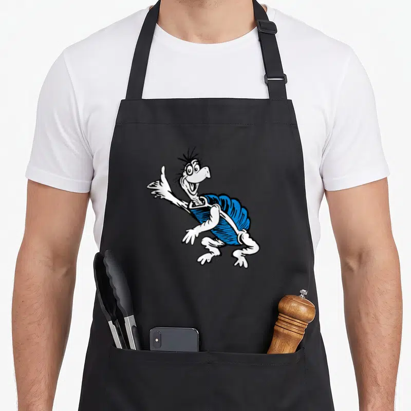 Yertle turtle apron - Cartoon turtle with blue shell and white body extending one arm forward — shown on a black cotton canvas apron against a white background
