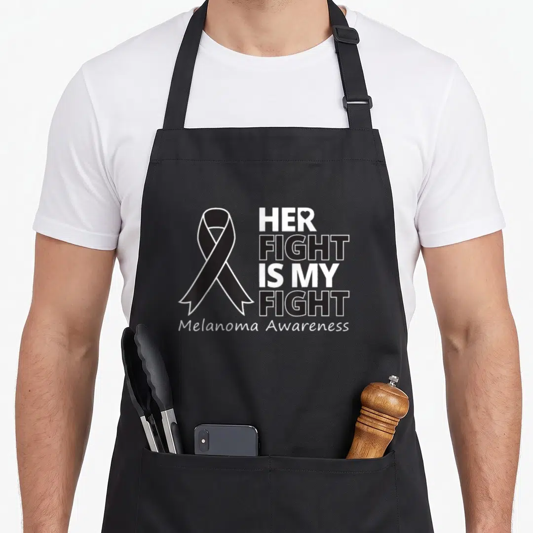 Fight melanoma awareness apron - Black awareness ribbon and stacked text HER FIGHT IS MY FIGHT Melanoma Awareness — shown on a black cotton canvas apron against a white background