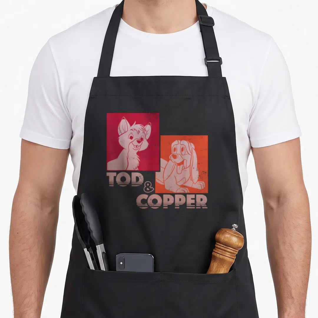 Tod fox print apron - Retro graphic of a fox and hound in stacked red and white squares with striped text below — shown on a black cotton canvas apron against a white background