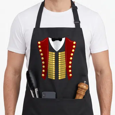 Ringmaster halloween party apron - Red military jacket with gold buttons and black bow tie on black bib apron — shown on a black cotton canvas apron against a white background