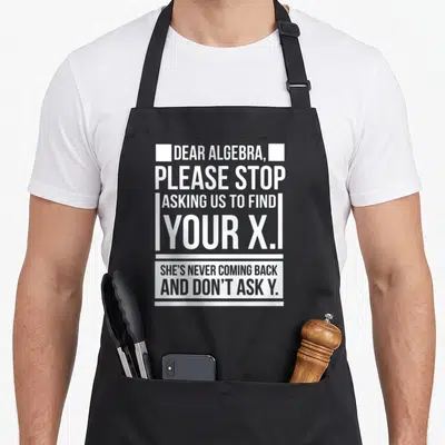 Dear nerd apron - White stacked text on black background reading Dear Algebra please stop asking us to find your x — shown on a black cotton canvas apron against a white background
