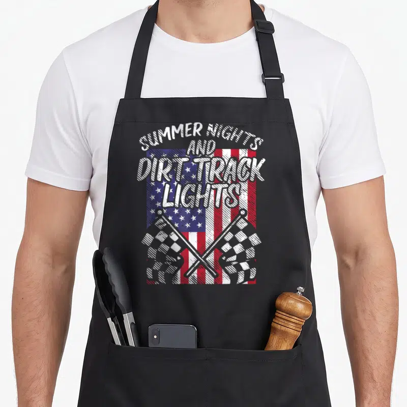 Light track apron - Stacked Summer Nights Dirt Track Lights text over distressed USA flag with two crossed checkered — shown on a black cotton canvas apron against a white background