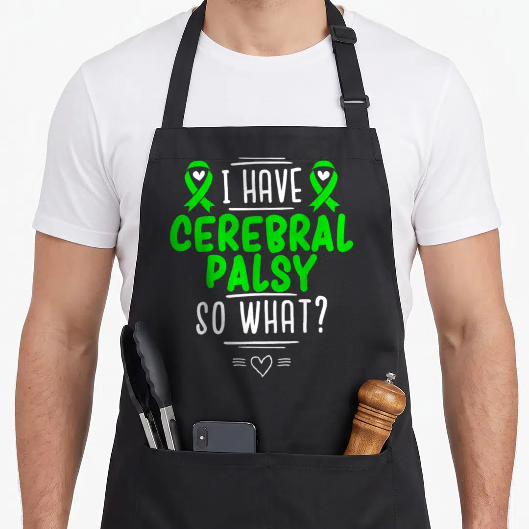 Survivor cerebral palsy awareness apron - Green and white I HAVE CEREBRAL PALSY SO WHAT text with two ribbons — shown on a black cotton canvas apron against a white background