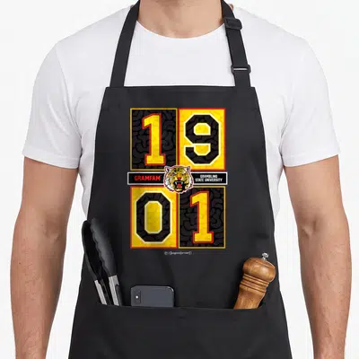 Grambling dungeon forward apron - Tiger head between 1901 numbers with Gramblinger State University text bars — shown on a black cotton canvas apron against a white background