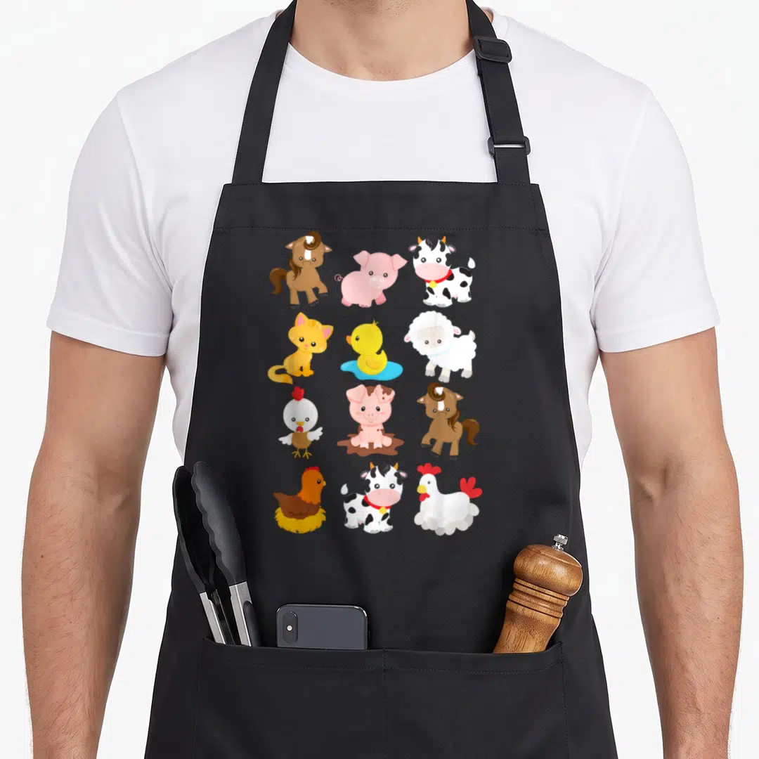 Farm sleeved aprons - Twelve cartoon farm animals in a grid including pink pig, brown horse, spotted cow, white sheep — shown on a black cotton canvas apron against a white background