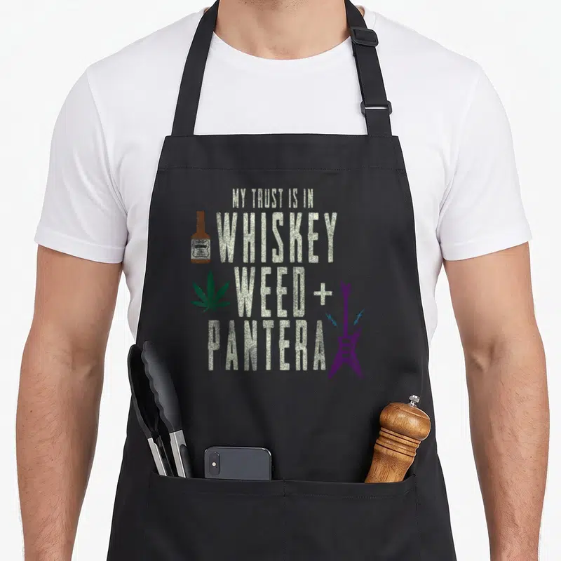 Pantera big band apron - Stacked text My Trust Is In Whiskey Weed + Pantera with bottle leaf and purple guitar — shown on a black cotton canvas apron against a white background