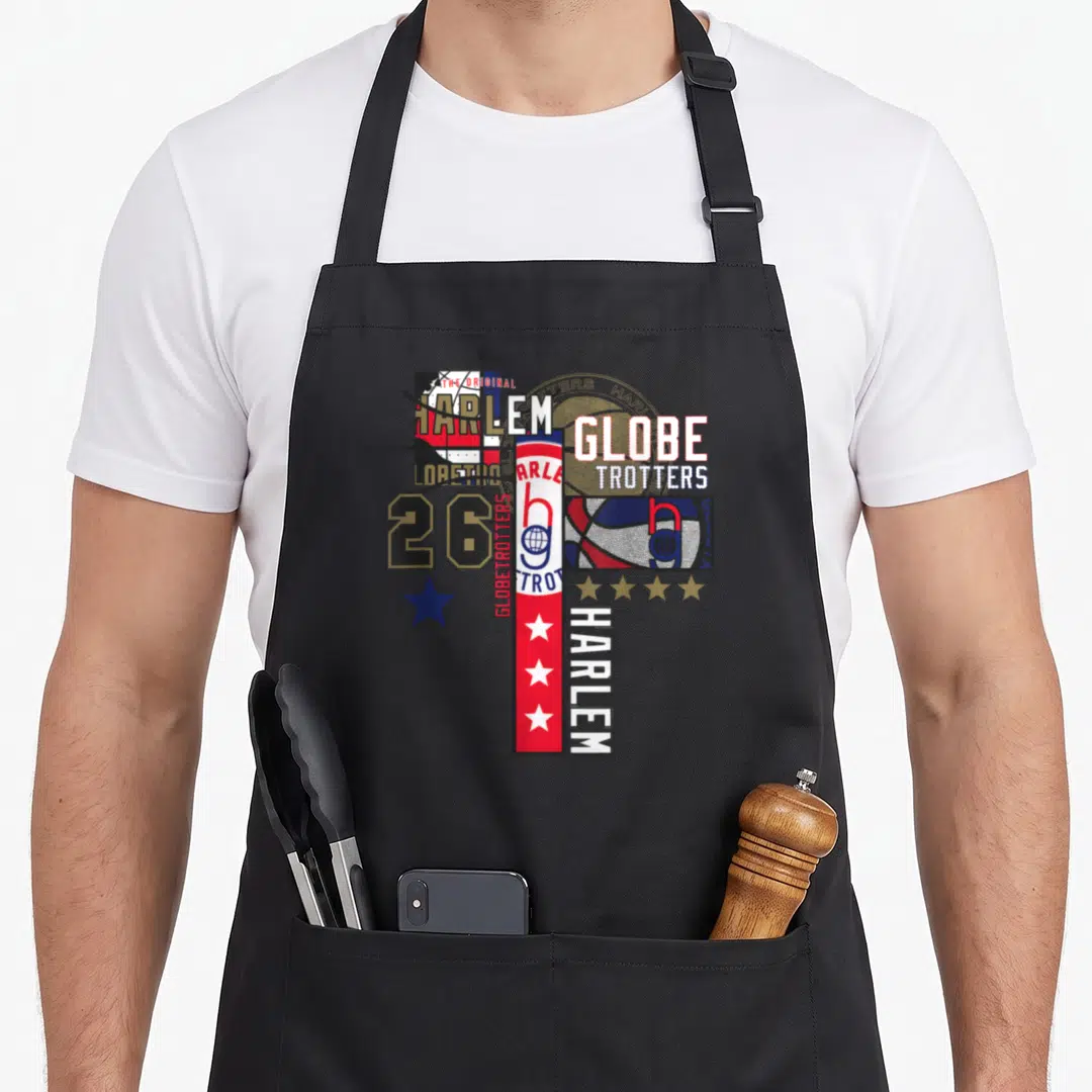 Globetrotter master apron - Distressed collage with HARLEM, GLOBE TROTTERS text, number 26, basketball, and stars — shown on a black cotton canvas apron against a white background