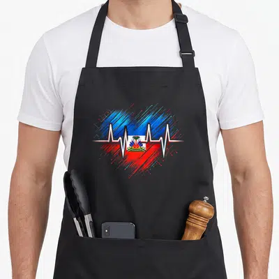 Root haitian apron - Retro heart of blue and red splatters with white heartbeat line and small Haitian flag centered — shown on a black cotton canvas apron against a white background