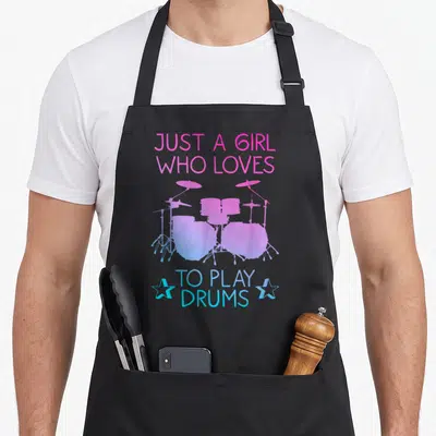 Drummer drumming drum apron - Pink and blue gradient drum kit silhouette with stars and text Just a Girl Who Loves — shown on a black cotton canvas apron against a white background