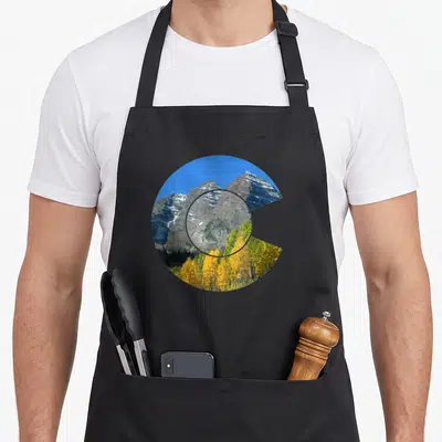 Bell colorado apron - Circular photo of grey mountains and yellow trees in a wedge shape — shown on a black cotton canvas apron against a white background