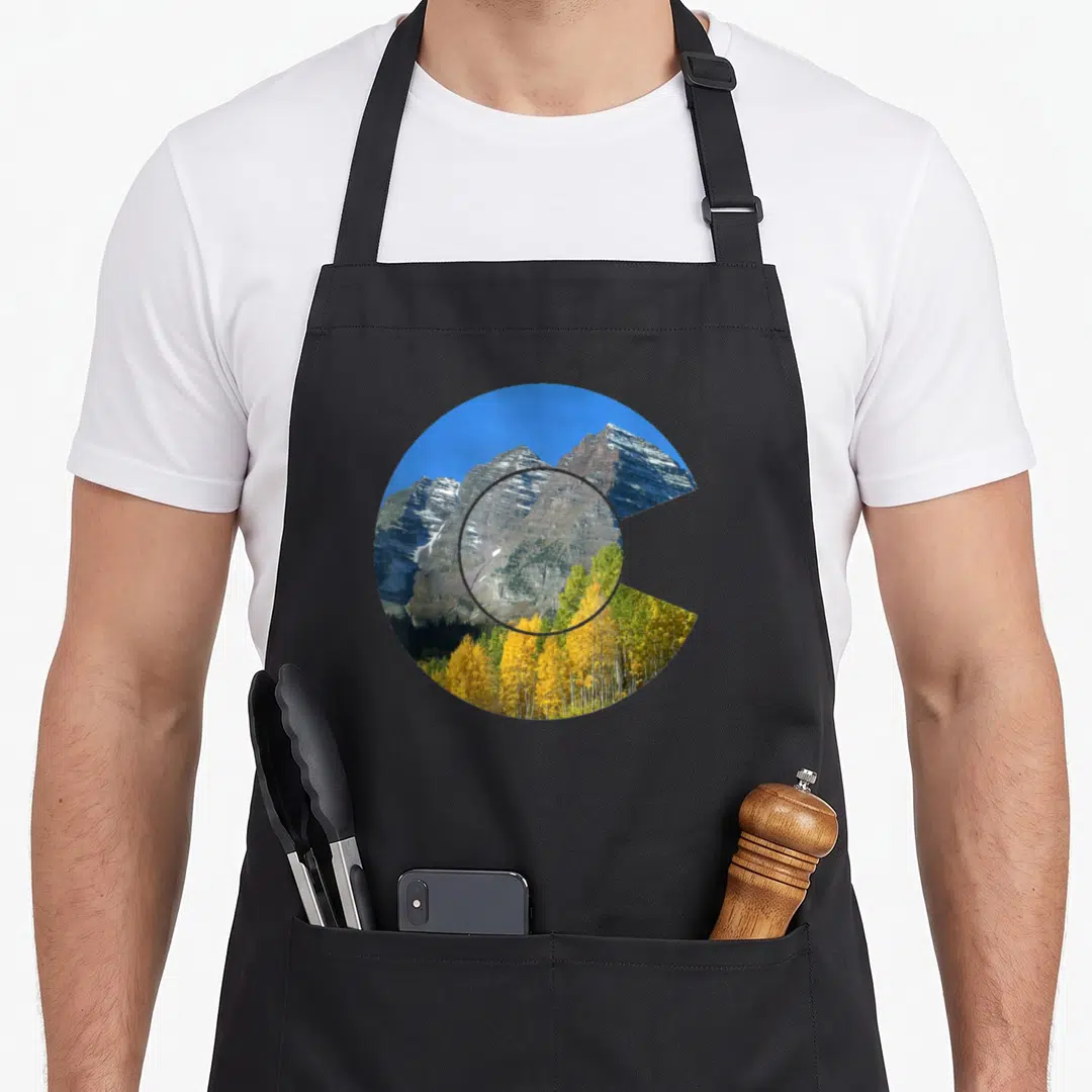 Bell colorado apron - Circular photo of grey mountains and yellow trees in a wedge shape — shown on a black cotton canvas apron against a white background