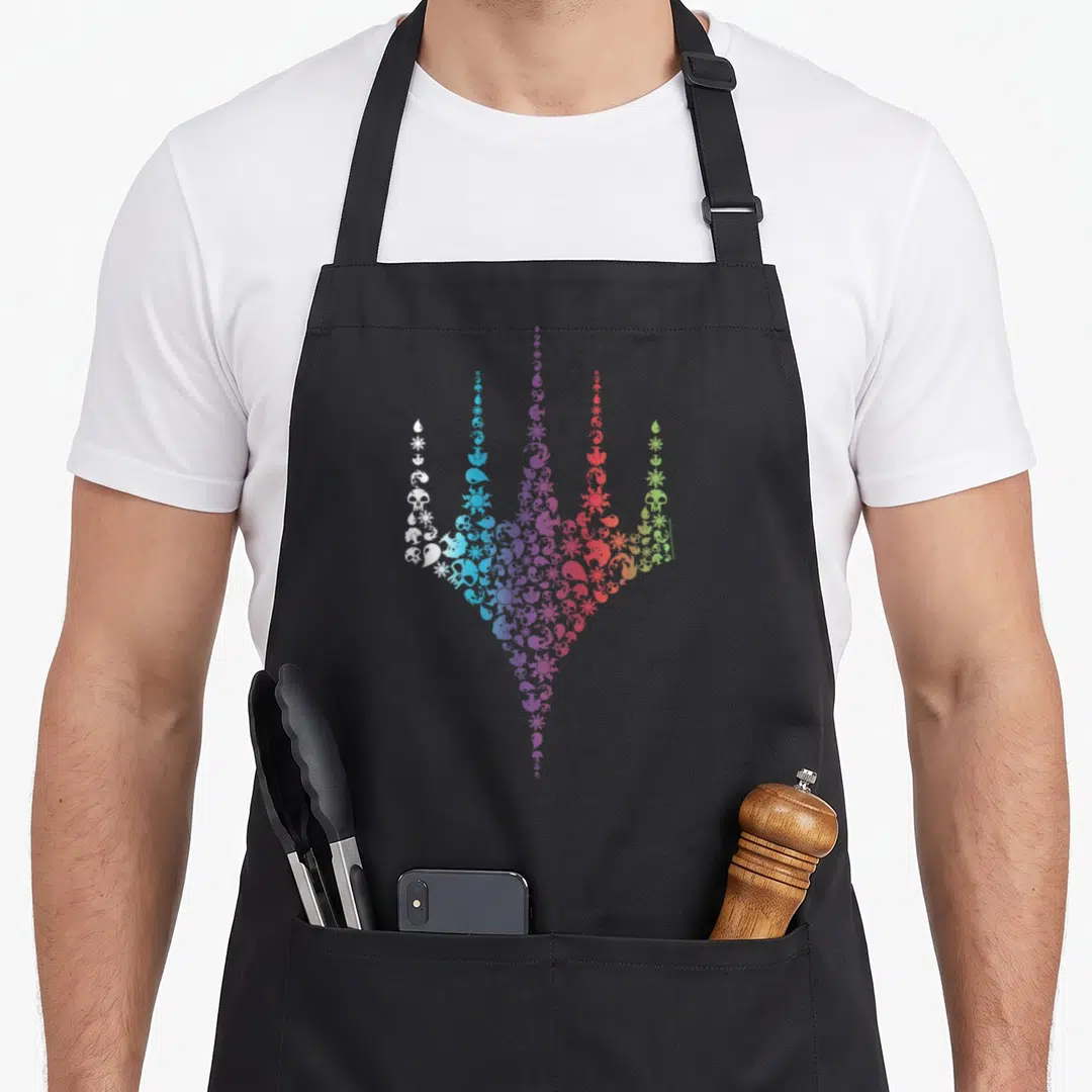 Rainbow icon magic apron - Trident shape made of skulls suns drops moons in white blue purple red green gradient — shown on a black cotton canvas apron against a white background