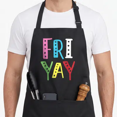Friyay weekend teacher apron - Stacked FRI YAY text in pink blue white green yellow red dotted chalkboard letters — shown on a black cotton canvas apron against a white background