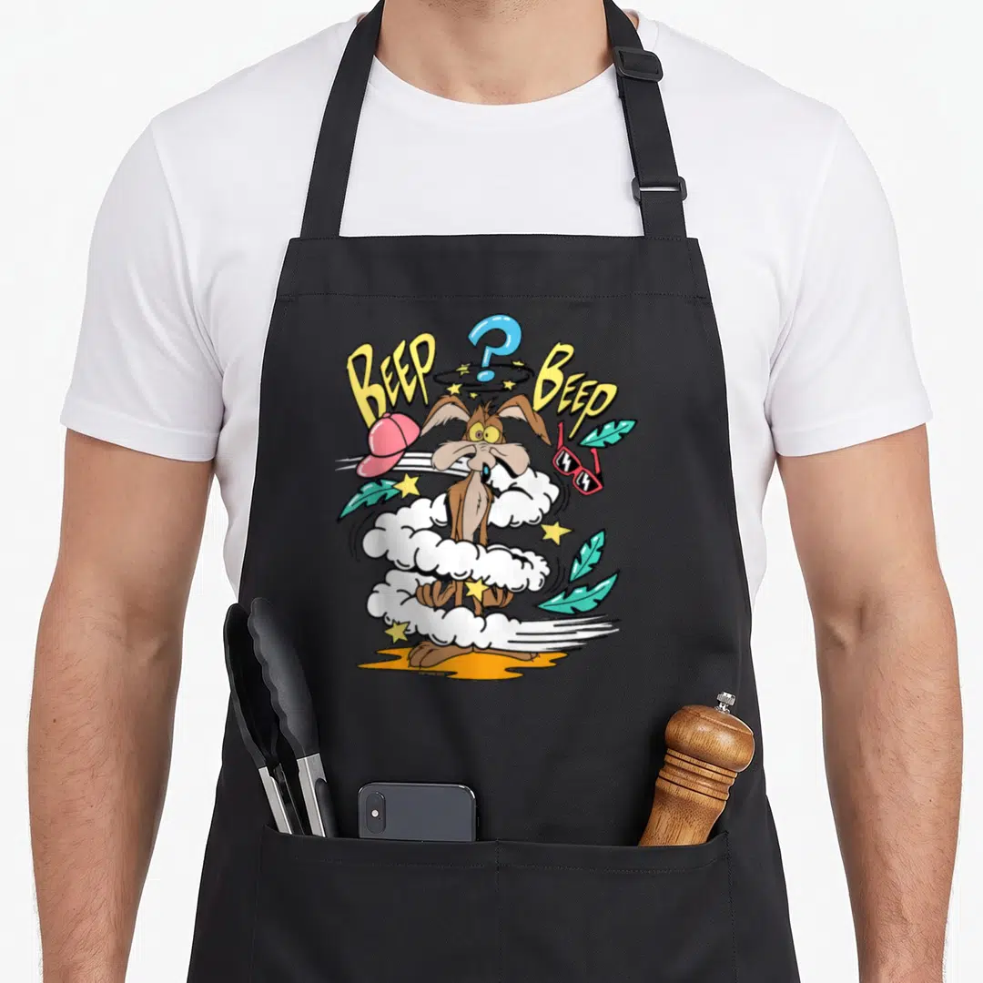 Beep e.a apron - Brown road runner with BEEP BEEP text, dust cloud, and floating cap glasses — shown on a black cotton canvas apron against a white background