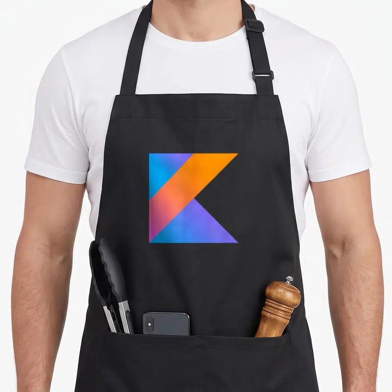 Kotlin programming apron - Geometric letter K logo in blue, orange, pink, and purple — shown on a black cotton canvas apron against a white background