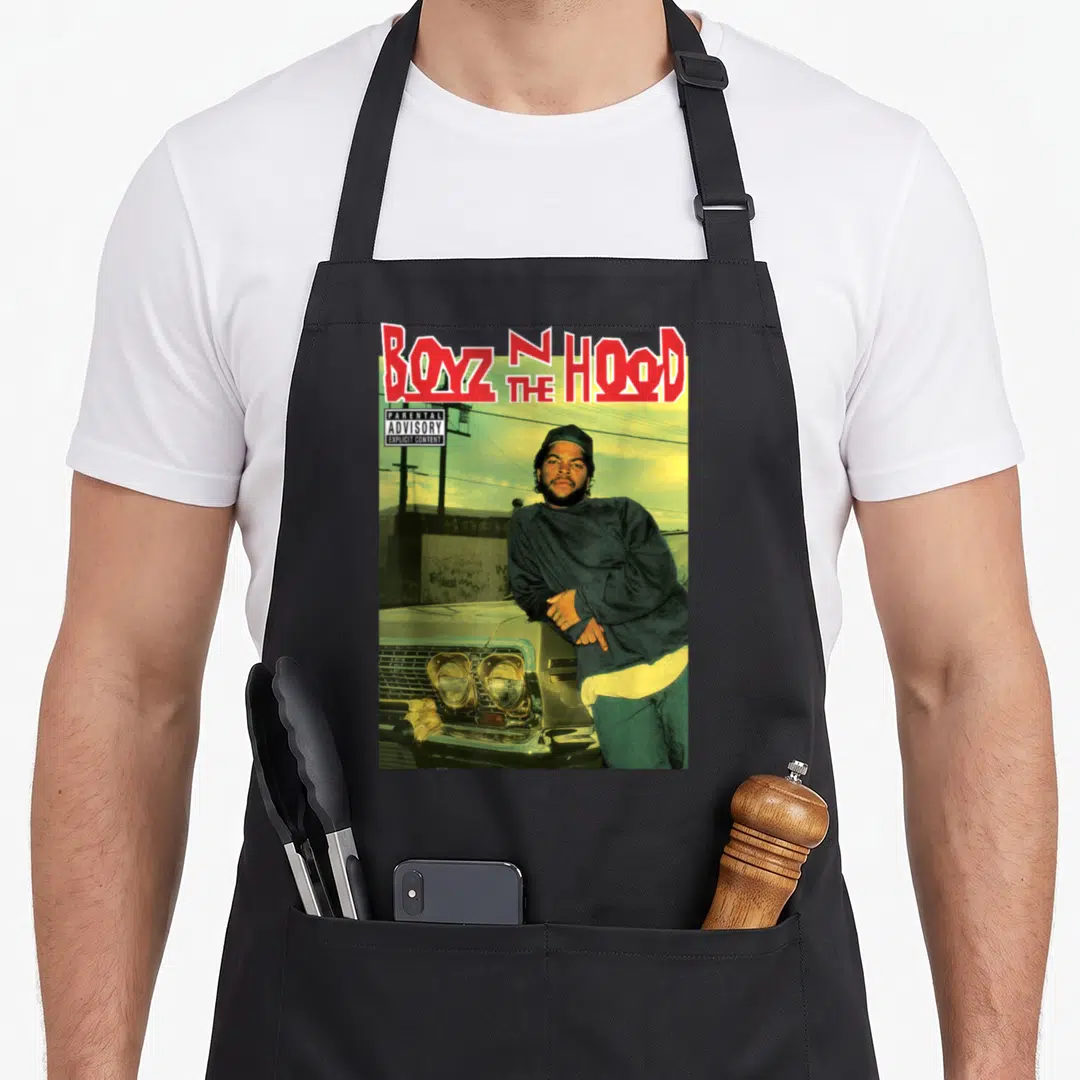 Boyz fanboy apron - Red BOYZ N THE HOOD text and man leaning on car with parental advisory label — shown on a black cotton canvas apron against a white background
