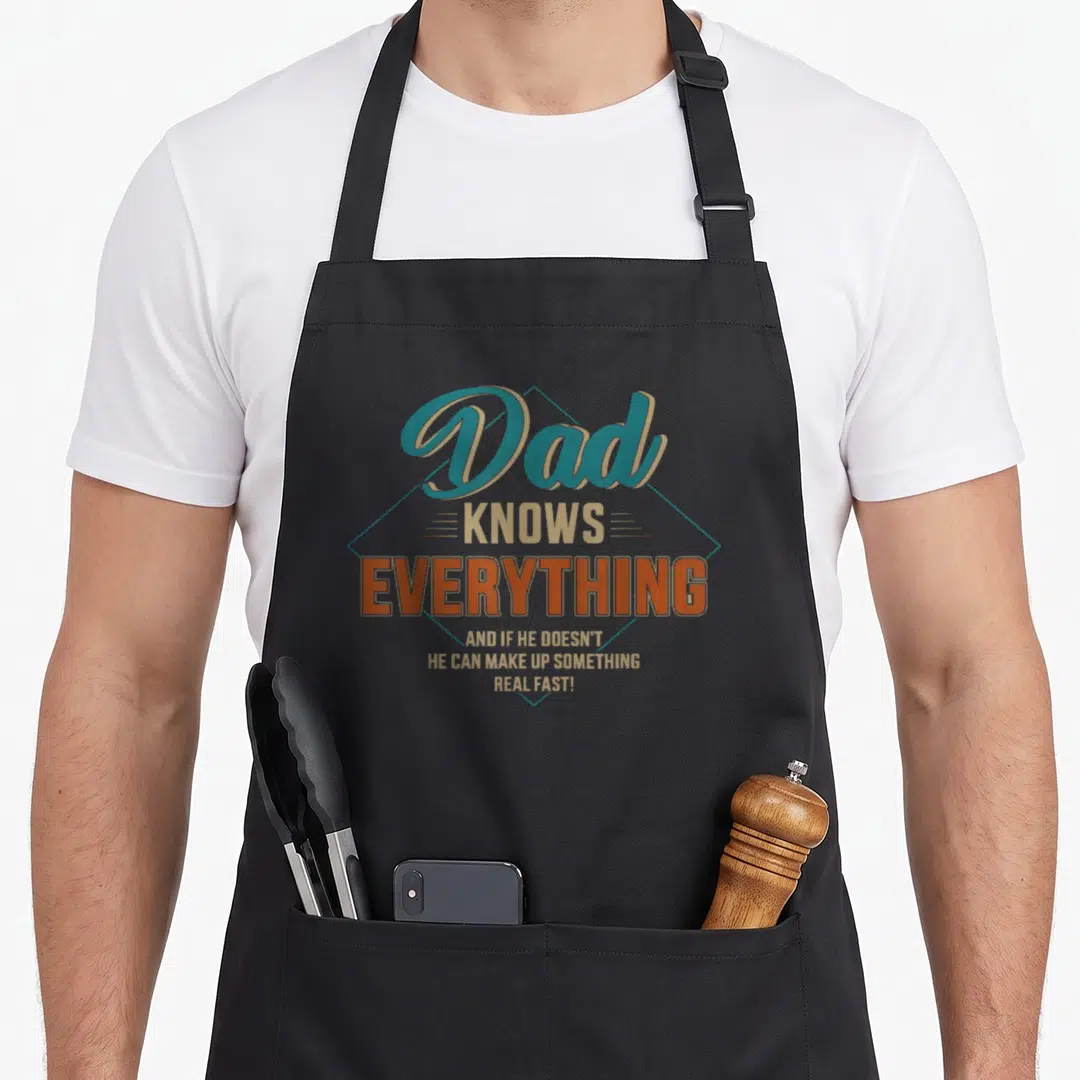 Food father day apron - Teal diamond frame containing Dad Knows Everything typography in tan and orange lettering — shown on a black cotton canvas apron against a white background