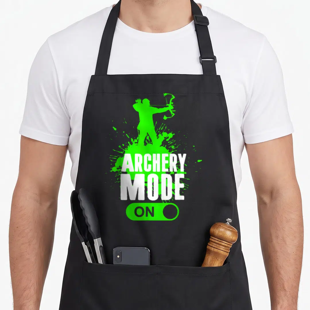 Mode bow apron - Green archer silhouette, white ARCHERY MODE ON text, green toggle switch — shown on a black cotton canvas apron against a white background