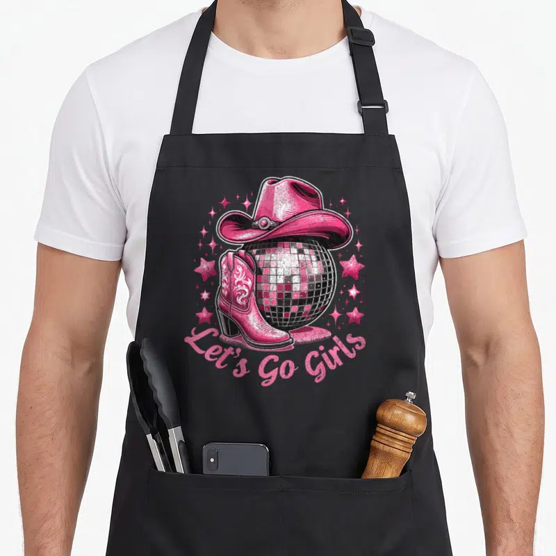 Bachelorette western apron - Pink cowboy hat on disco ball with boot and stars — shown on a black cotton canvas apron against a white background
