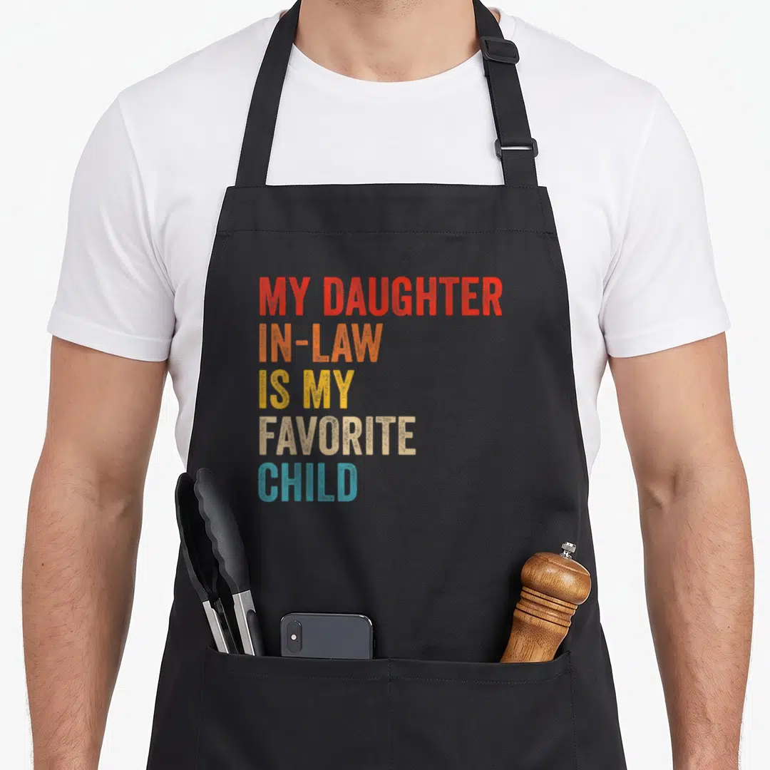 Law family mom and daughter aprons - Stacked colorful text reading My Daughter In-Law Is My Favorite Child in red — shown on a black cotton canvas apron against a white background