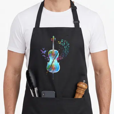 Classical cello apron - Watercolor cello with bow, swirling notes, butterflies in blue green yellow red purple — shown on a black cotton canvas apron against a white background