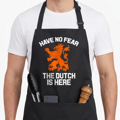 Overijssel netherlands apron - Orange distressed lion with white text HAVE NO FEAR THE DUTCH IS HERE — shown on a black cotton canvas apron against a white background