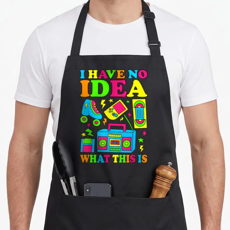 70s 80s 90s chef outfit with apron - Neon retro boombox, roller skate, and cassette tape with bold colorful lettering — shown on a black cotton canvas apron against a white background