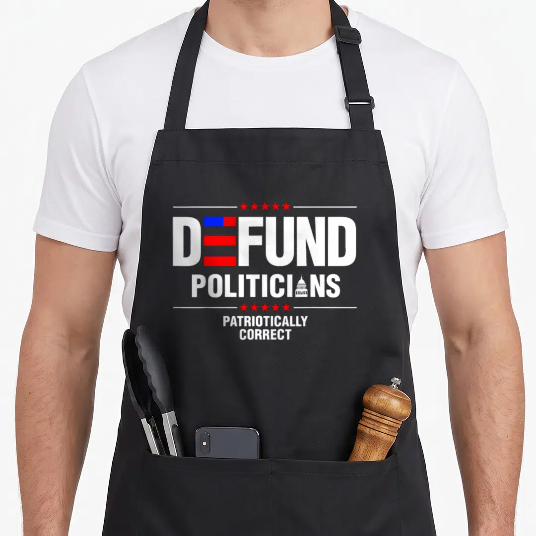 Patriotically politician apron - DEFUND POLITICIANS text with flag E, capitol O, and red stars in white, red, and blue — shown on a black cotton canvas apron against a white background