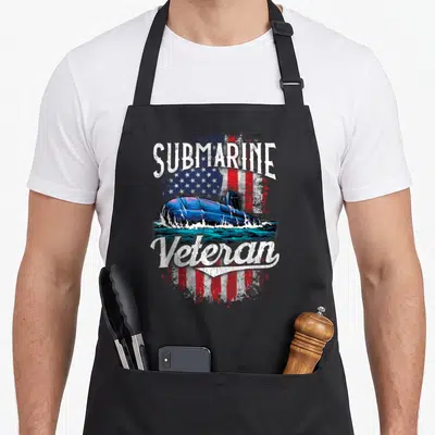 Veteran service apron - Blue submarine emerging from water below SUBMARINE text and above Veteran text against — shown on a black cotton canvas apron against a white background