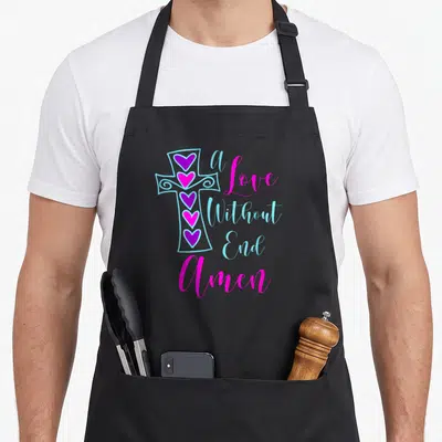 End amen christian apron - Light blue cross with four pink and purple hearts next to A Love Without End Amen text — shown on a black cotton canvas apron against a white background